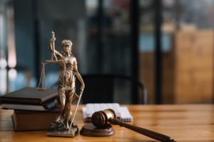 Statue of lady justice, gavel, and law book on the desk of a Bankruptcy Attorney Avondale AZ